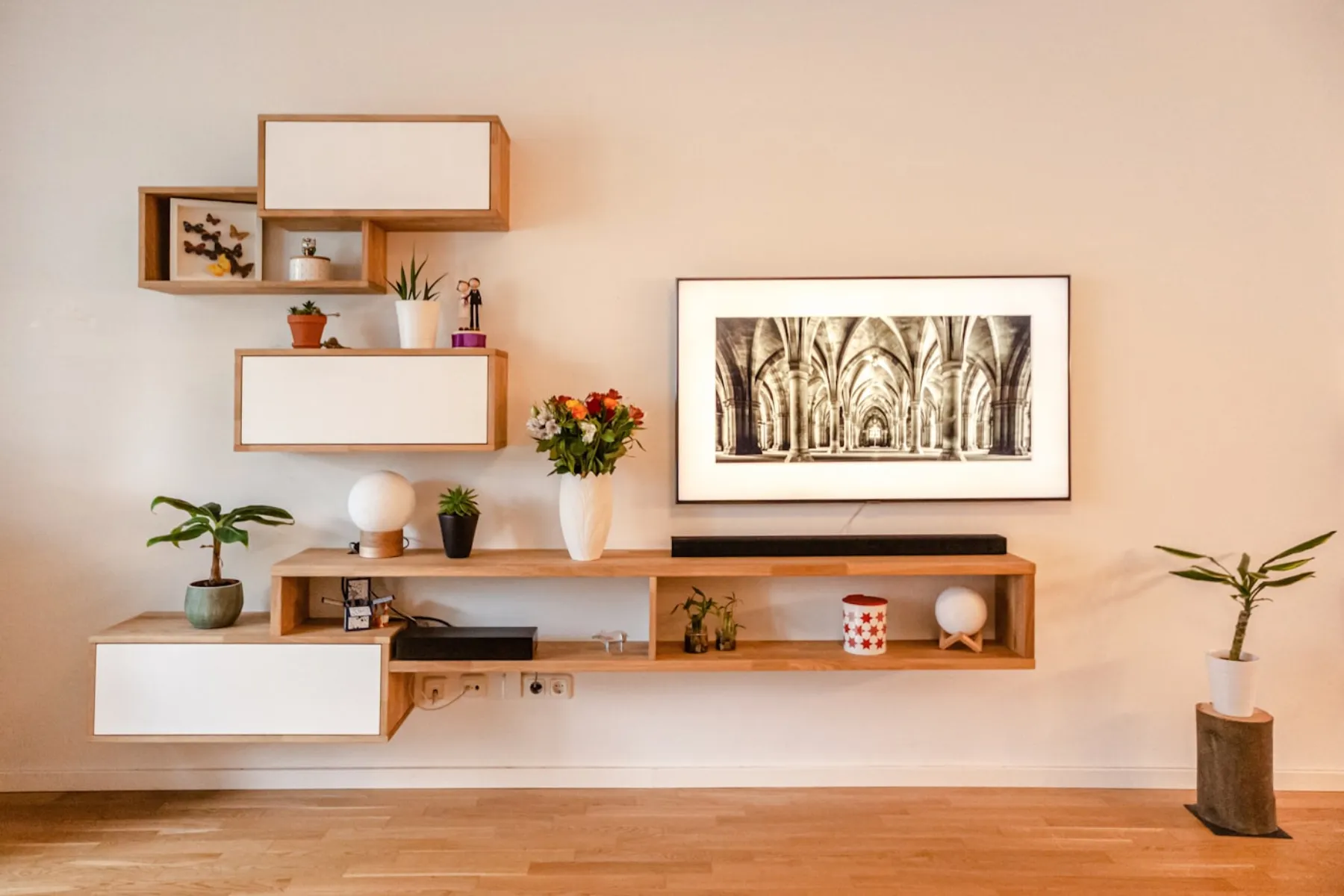 A calm, tidy shelf styled with plants and simple objects